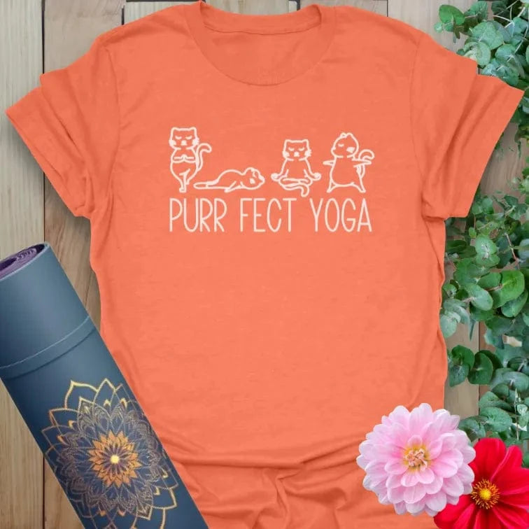 Vibrant orange yoga t-shirt showcasing cute cat yoga pose artwork inspiring soulful movement and joyful mindfulness.