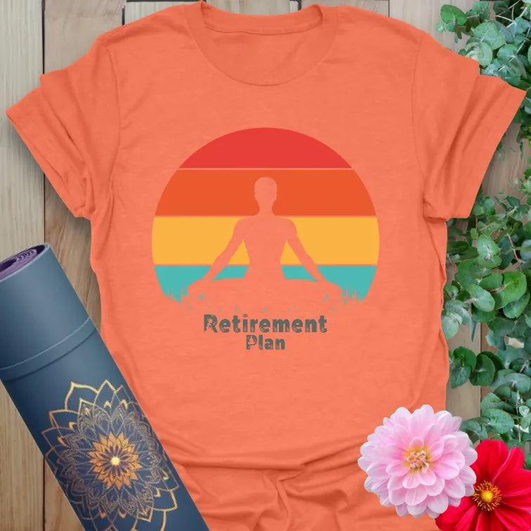 Vibrant orange yoga t-shirt showcasing retro sunset meditation artwork inspiring mindful planning and joyful presence.