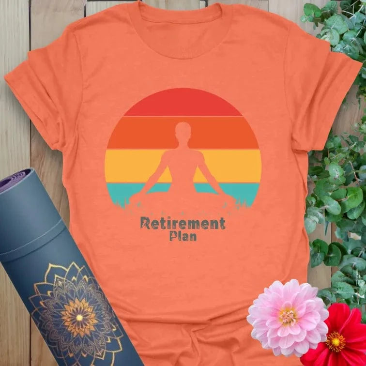 Vibrant orange yoga t-shirt showcasing retro sunset meditation artwork inspiring mindful planning and joyful presence.