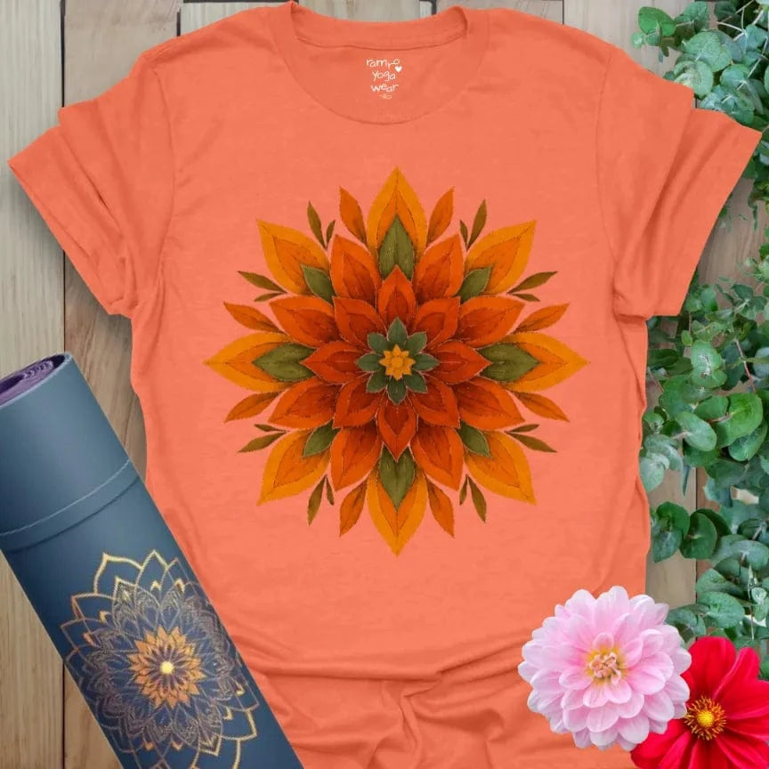 Vibrant orange yoga t-shirt showcasing fiery mandala flower artwork inspiring spiritual awakening and joyful, conscious living