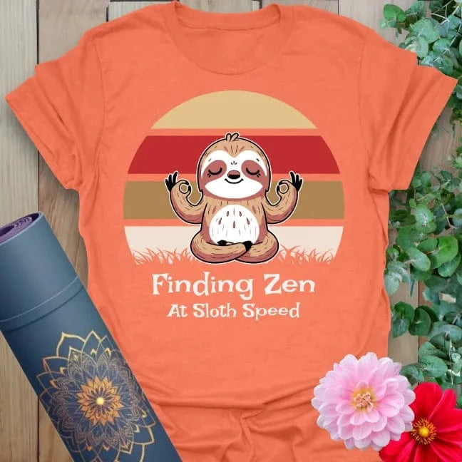 Vibrant orange yoga t-shirt showcasing chill sloth and mindfulness mantra inspiring conscious slow movement and joyful stillness.