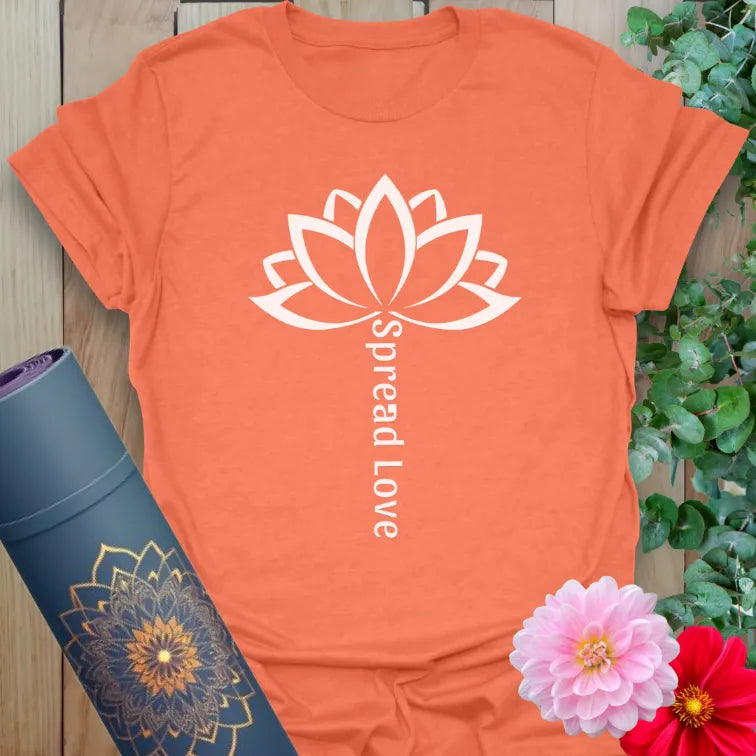 Vibrant orange yoga tee with blooming lotus and vertical inspirational message for conscious lifestyle.