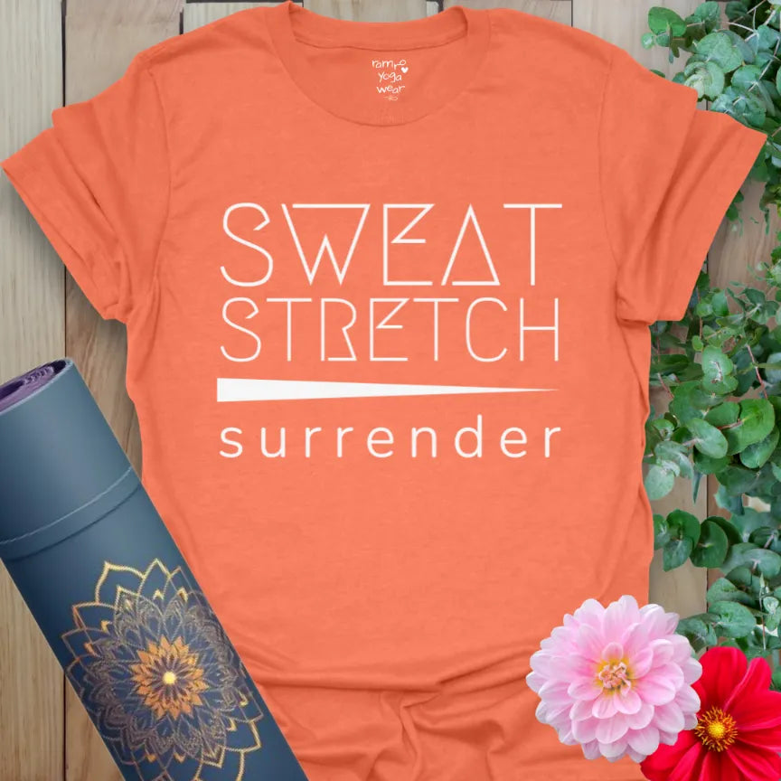Heather Orange Sweat Stretch T-Shirt with white bold text reading “Sweat. Stretch. Surrender.” Energetic yoga shirt for fiery practice.