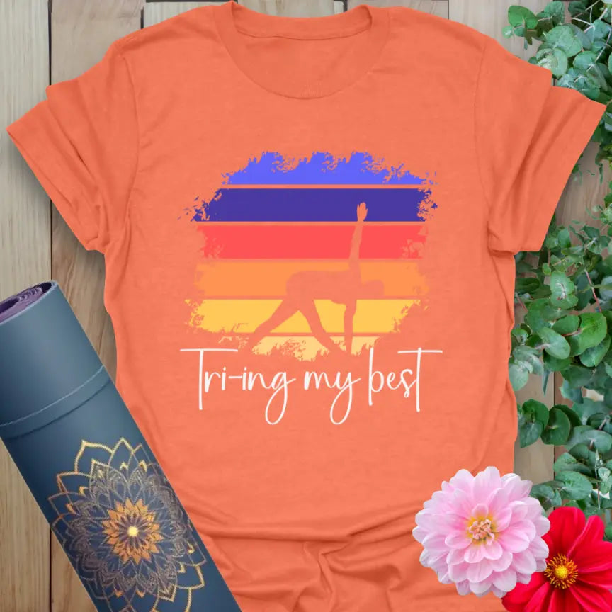 Vibrant orange t-shirt with playful yoga pose design and motivational message for heartfelt practice and conscious style.