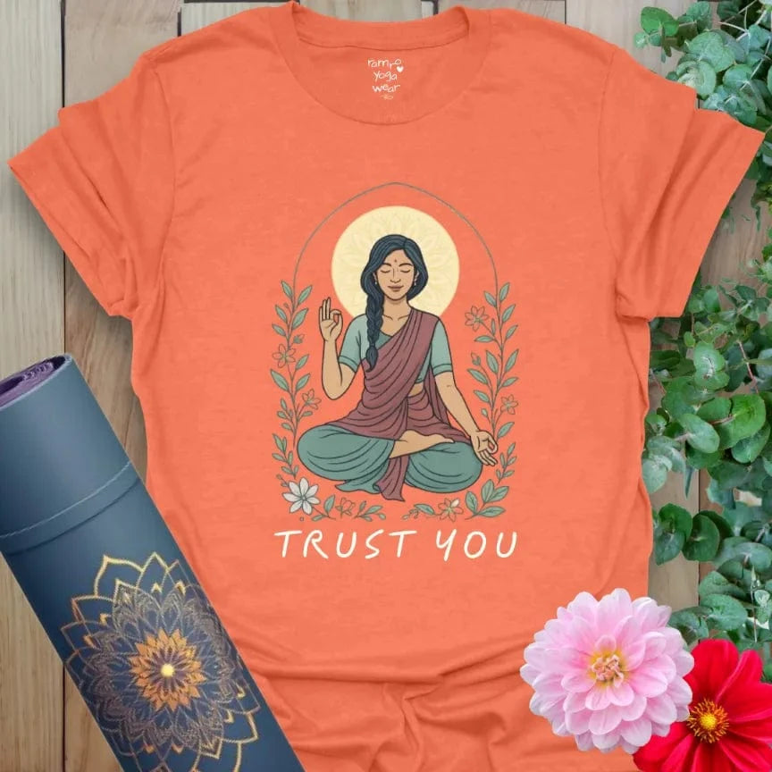 Vibrant orange t-shirt with divine feminine yoga art and soulful “Trust You” quote for conscious, empowered wear.