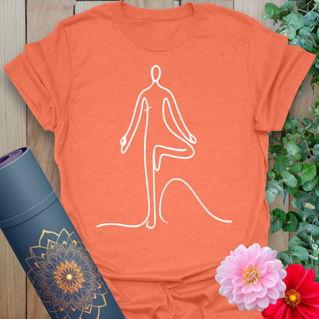 Vibrant orange t-shirt with flowing white Vrksasana line art for conscious, centered yoga practice.