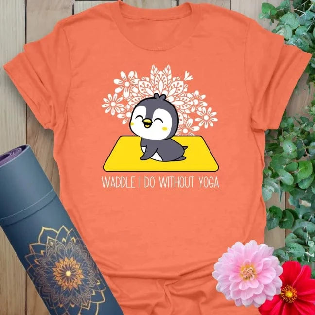 Vibrant orange t-shirt with adorable penguin in lotus pose and snowflake mandala design for playful yoga wear.