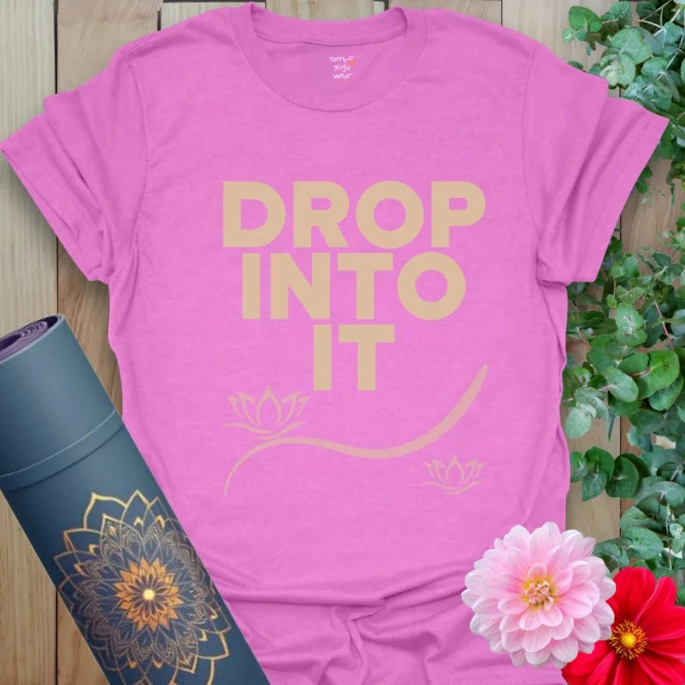 Drop Into It T-Shirt in Heather Radiant Orchid with bold white text and peaceful lotus. Perfect for yoga, meditation, or thoughtful gifting.