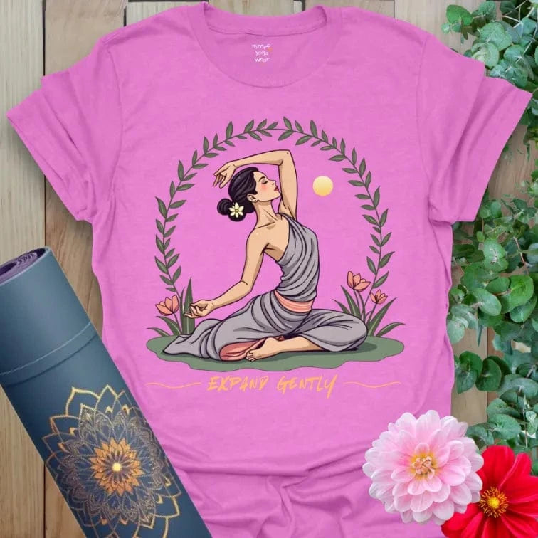 Radiant orchid-colored yoga tee with yogini in graceful yoga pose, floral wreath, and sun symbolizing gentle expansion.