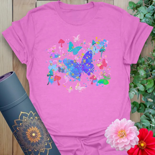 Radiant orchid-colored yoga tee with whimsical butterfly and mushroom collage celebrating growth and free spirit energy.