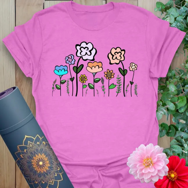 Radiant orchid-colored yoga tee with cheerful hand-drawn wildflowers inspiring natural beauty and conscious movement.