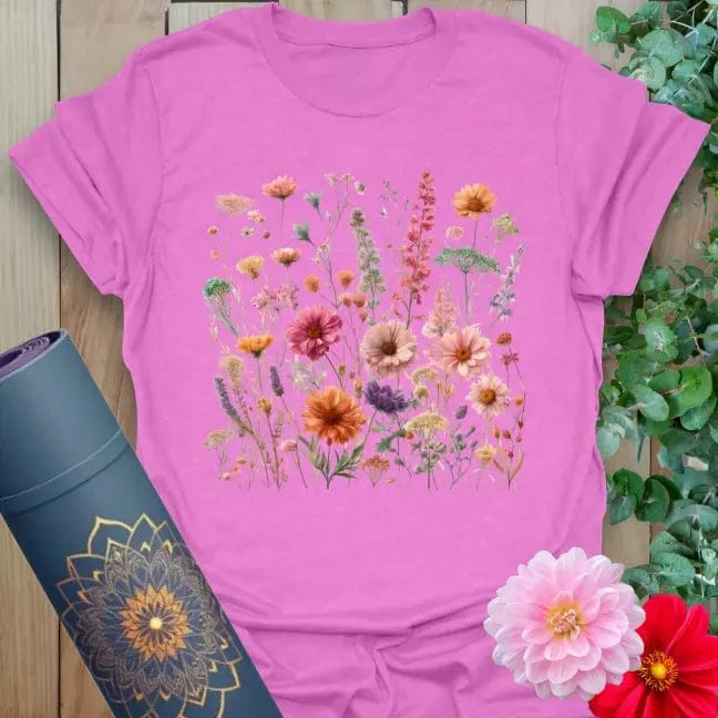 Radiant orchid-colored yoga tee with lush field of wildflowers and gerbera daisies inspiring soulful, joyful growth.
