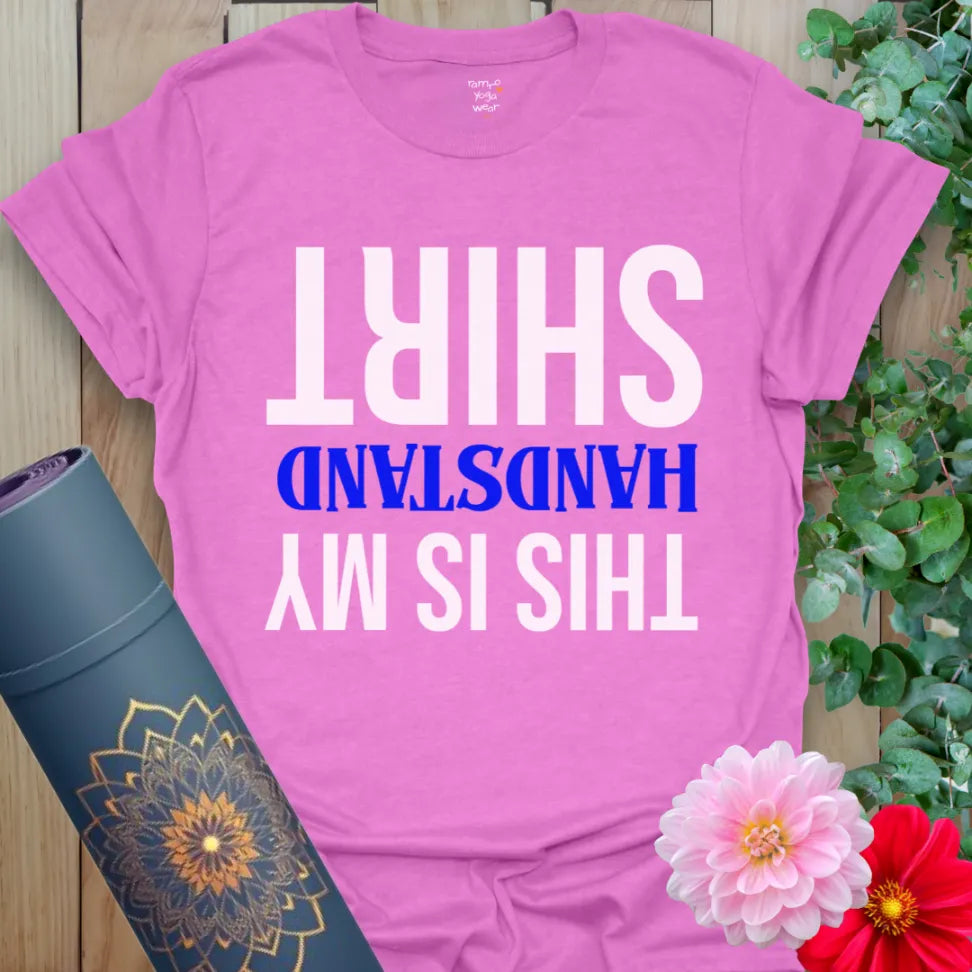 Radiant orchid-colored yoga tee with playful upside-down handstand quote for light-hearted soulful expression.