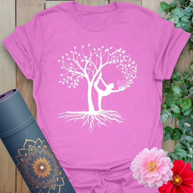 Radiant orchid-colored yoga tee featuring rooted Tree Pose figure symbolizing grounded movement and inspired growth.