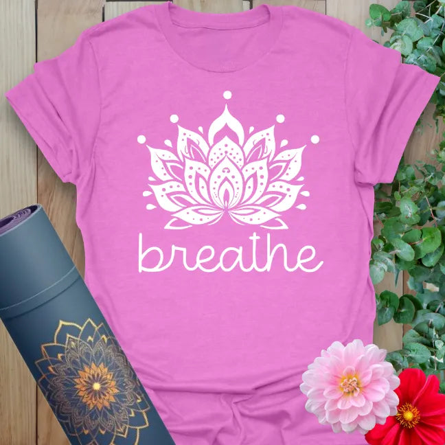 Radiant orchid-colored yoga tee with graceful lotus flower and "breathe" script symbolizing peace and mindful movement.