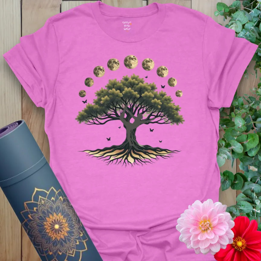 Radiant orchid-colored yoga tee with grounded tree and celestial moon phases celebrating spiritual growth and connection.