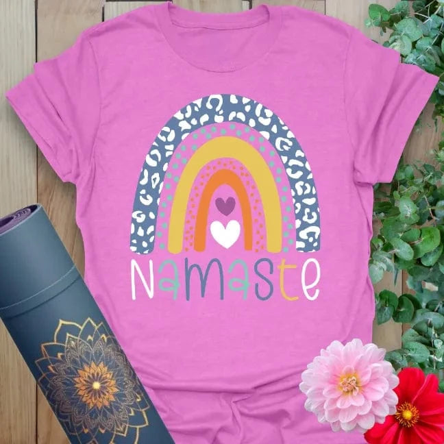 Radiant orchid-colored yoga tee with colorful rainbow and Namaste script celebrating gratitude, joy, and mindful presence.