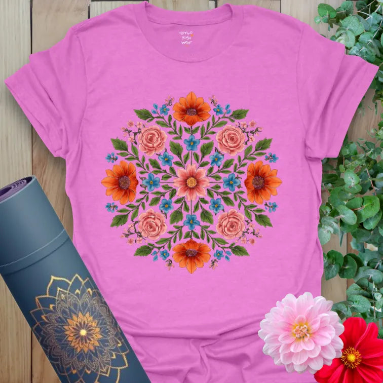 Radiant orchid-colored yoga tee with lush floral mandala design celebrating conscious blooming and soulful living.
