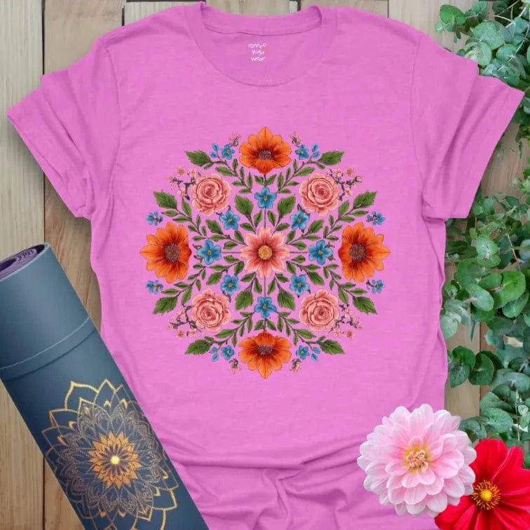 Radiant orchid-colored yoga tee with lush floral mandala design celebrating conscious blooming and soulful living.
