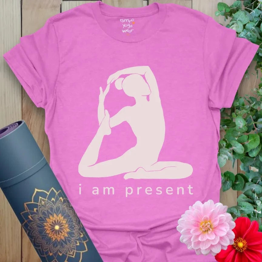 Heather Radiant Orchid Present T-Shirt with yogi in King Pigeon Pose and text “i am present.” Mindful yoga affirmation shirt.