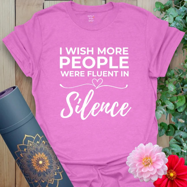 Radiant orchid-colored yoga tee with playful "Fluent in Silence" message celebrating peaceful, heart-centered living.