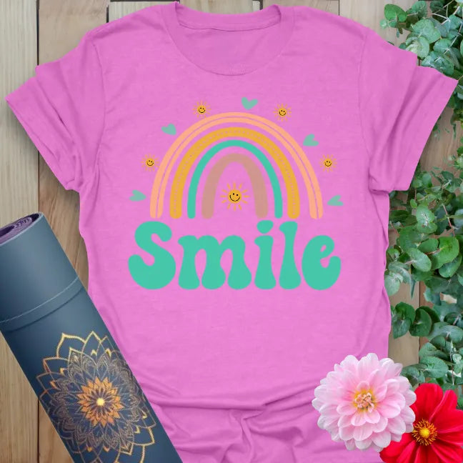 Radiant orchid-colored yoga tee with colorful rainbow and happy affirmation inspiring joyful, heart-centered living.