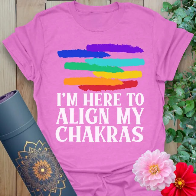 Radiant orchid-colored yoga tee showcasing colorful chakra brush design and bold mindful mantra for conscious living.