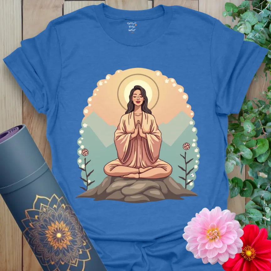 Soft cotton unisex yoga t-shirt featuring serene meditating figure with mountain and halo design symbolizing inner peace.