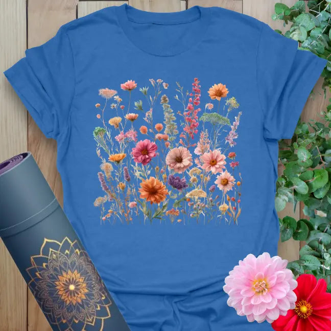 Soft cotton unisex yoga t-shirt featuring vibrant field of wildflowers and gerbera daisies symbolizing joyful, soulful living.