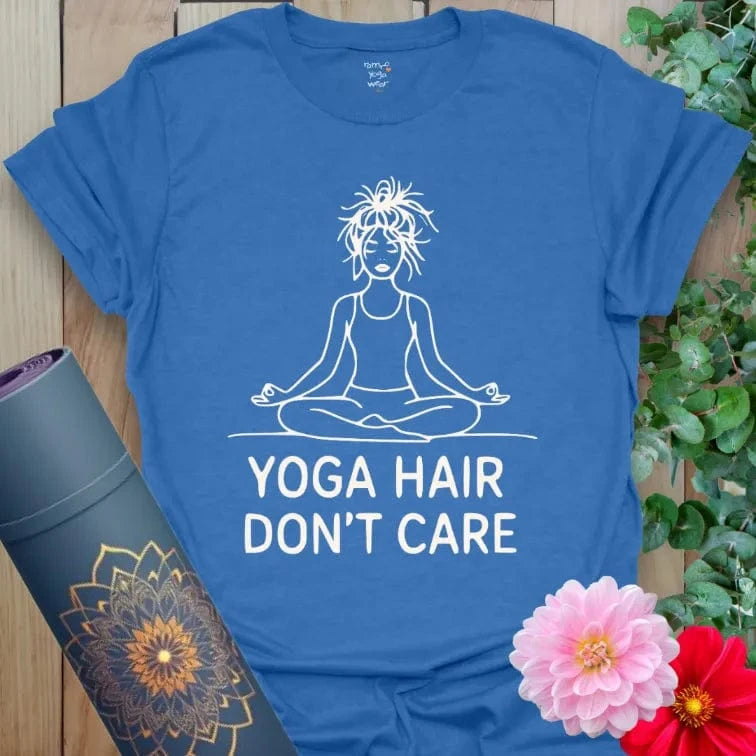 Heather Royal Hair T-Shirt with bold white print: seated yogi, messy hair, and “Yoga Hair Don’t Care” slogan. Unisex yoga and activewear tee.