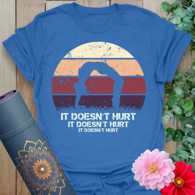 Soft cotton unisex yoga t-shirt featuring funny "It Doesn't Hurt" mantra with yogi backbend pose and retro sunset for mindful, joyful living.