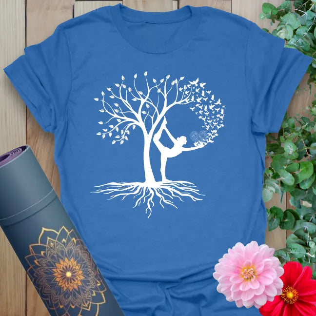 Soft cotton unisex yoga t-shirt featuring elegant yogi in Tree Pose blending with flourishing tree symbolizing growth and balance.