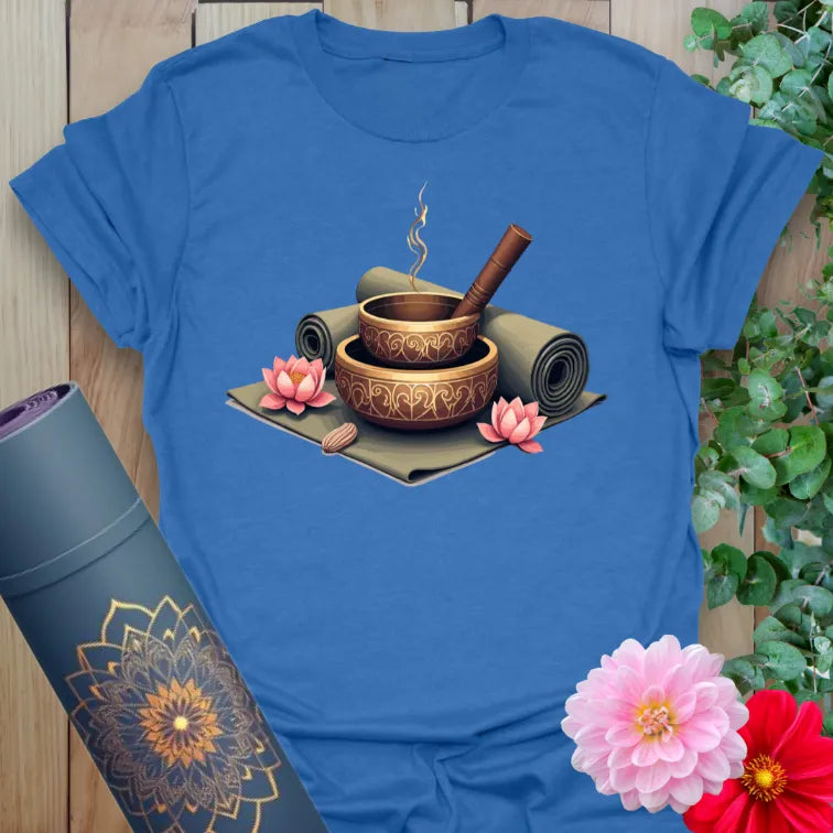 Soft cotton unisex yoga t-shirt featuring singing bowls, incense, and yoga mat design symbolizing sacred mindfulness and soulful harmony.