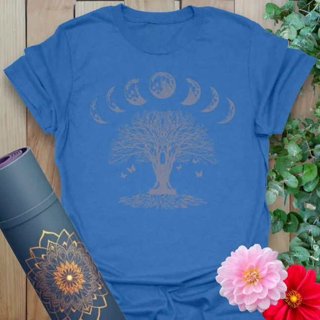 Soft cotton unisex yoga t-shirt featuring tree of life crowned by moon phases and butterflies symbolizing grounded growth and cosmic connection.