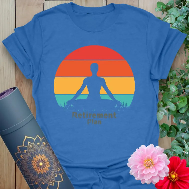 Soft cotton unisex yoga t-shirt featuring serene meditating silhouette and vibrant sunset with "Retirement Plan" quote for soulful living.