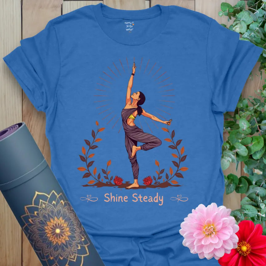 Soft cotton unisex yoga t-shirt featuring radiant tree pose yogi with sunburst and floral grounding design for steady, soulful living.