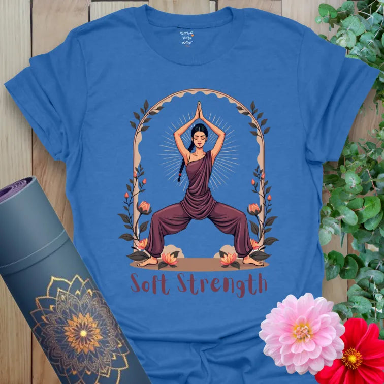 Soft cotton unisex yoga t-shirt featuring yogi in Goddess Pose with botanical frame and “Soft Strength” mantra for mindful empowerment.