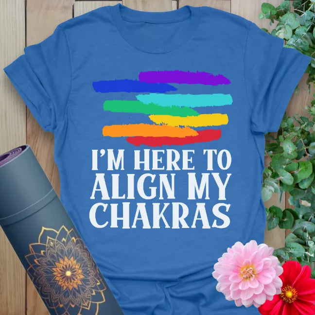 Soft cotton unisex yoga t-shirt featuring chakra-inspired rainbow brushstrokes and bold “I’m Here to Align My Chakras” quote.