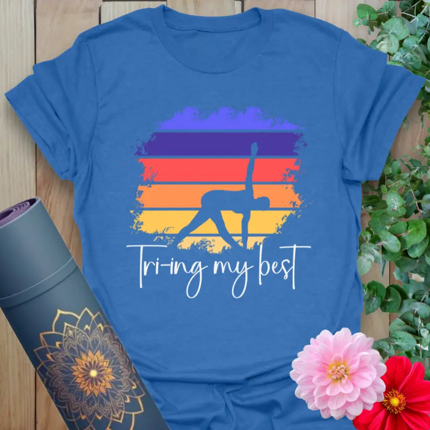 Soft cotton yoga tee featuring Triangle Pose silhouette with sunset background and “Trying My Best” quote for mindful humor and movement.