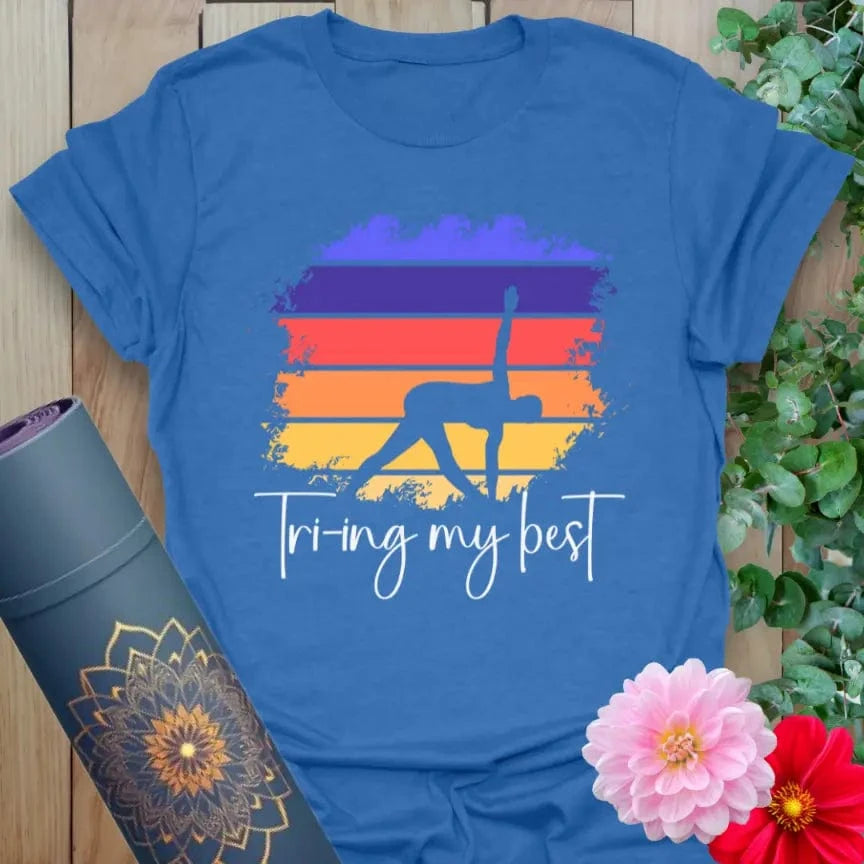 Soft cotton yoga tee featuring Triangle Pose silhouette with sunset background and “Trying My Best” quote for mindful humor and movement.