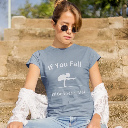 Woman wearing the If You Fall T-Shirt in Stone Blue, sitting outdoors with sunglasses — The Vault collection by Ramro Yoga Wear