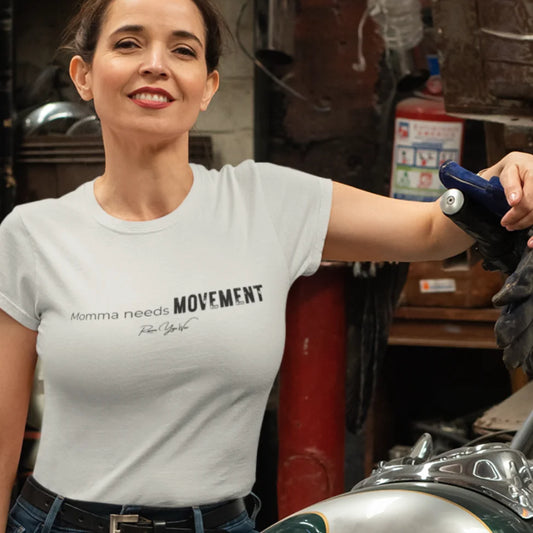 Person wearing the Movement T-Shirt in Heather Prism Natural, standing indoors in a garage setting — Funny Yoga Shirts collection by Ramro Yoga Wear.
