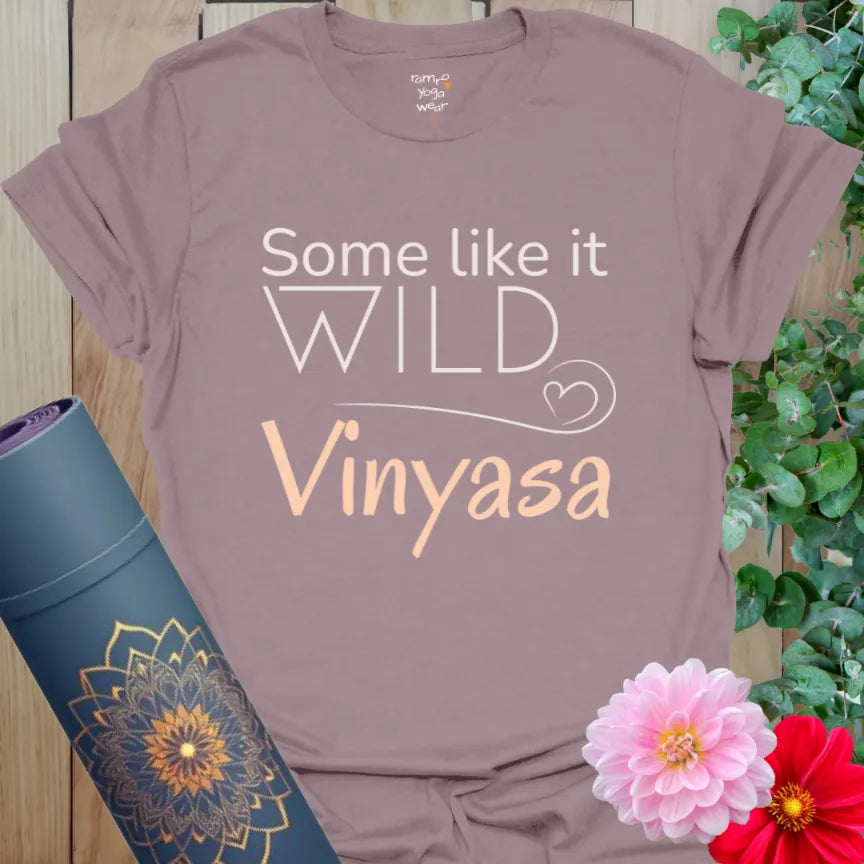 Paragon Vinyasa T-Shirt with peach script and “Some Like It Wild – Vinyasa” text. Whimsical yoga tee for flowy movers.