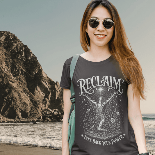 Ramro Yoga Wear Reclaim tee in Dark Heather Grey — woman rising wildflowers take back your power vintage design, coastal sea rocks lifestyle shot