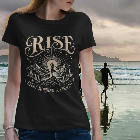 Ramro Yoga Wear Rise tee in Black — vintage mountain yoga sunrise design, beach stormy sky lifestyle shot