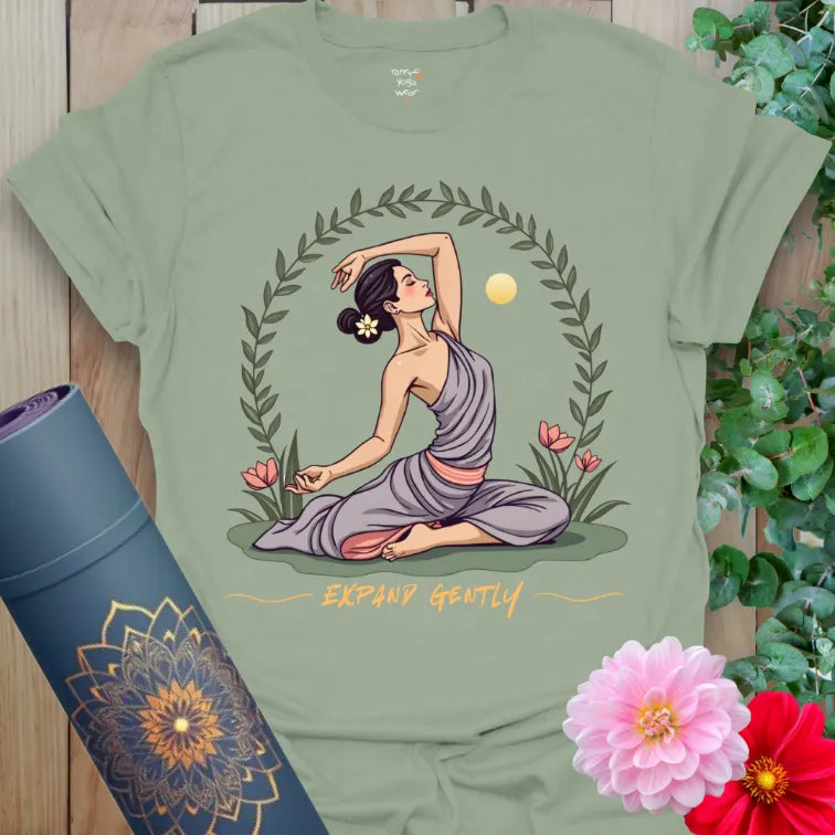 Calm sage green yoga t-shirt featuring blooming lotus and a yogi pose within a nature-inspired circle for soulful living.