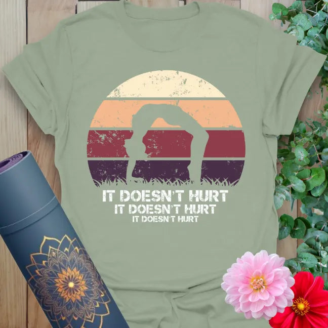 Calm sage green yoga t-shirt featuring funny "It Doesn't Hurt" backbend pose artwork perfect for soulful, joyful practice.