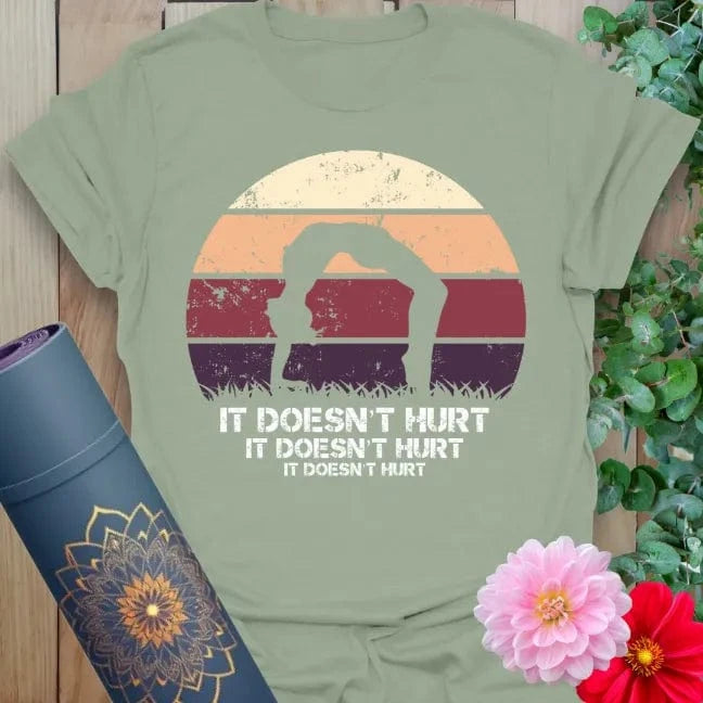 Calm sage green yoga t-shirt featuring funny "It Doesn't Hurt" backbend pose artwork perfect for soulful, joyful practice.