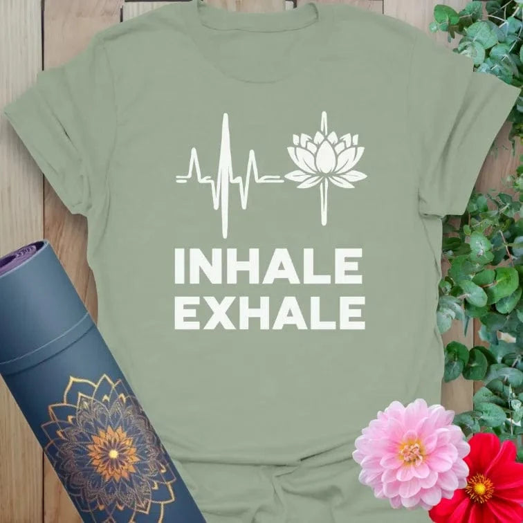Calm sage green yoga t-shirt with "Inhale Exhale" lotus design symbolizing peace, mindfulness, and soulful breathing.