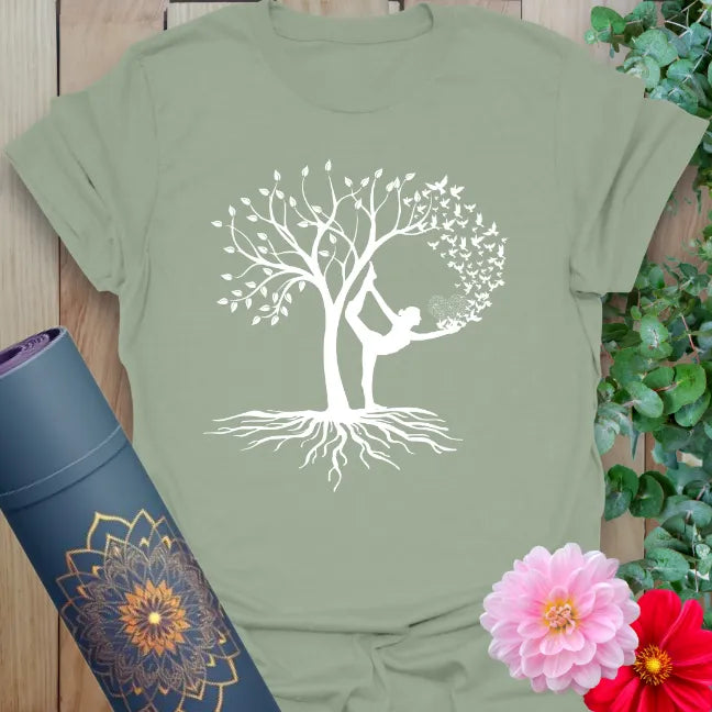 Calm sage green yoga t-shirt with elegant yogi and flourishing tree artwork for earth-connected, conscious living.